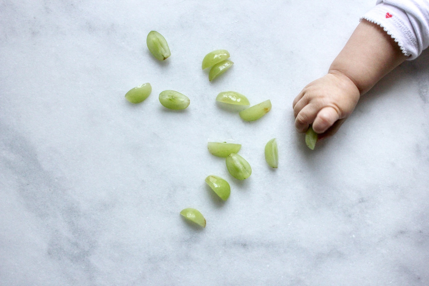 Baby eating grapes