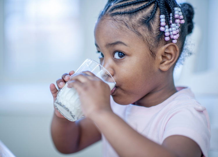 Toddler drinking glass of milk